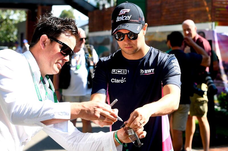 Racing Point driver Sergio Perez signs an autograph