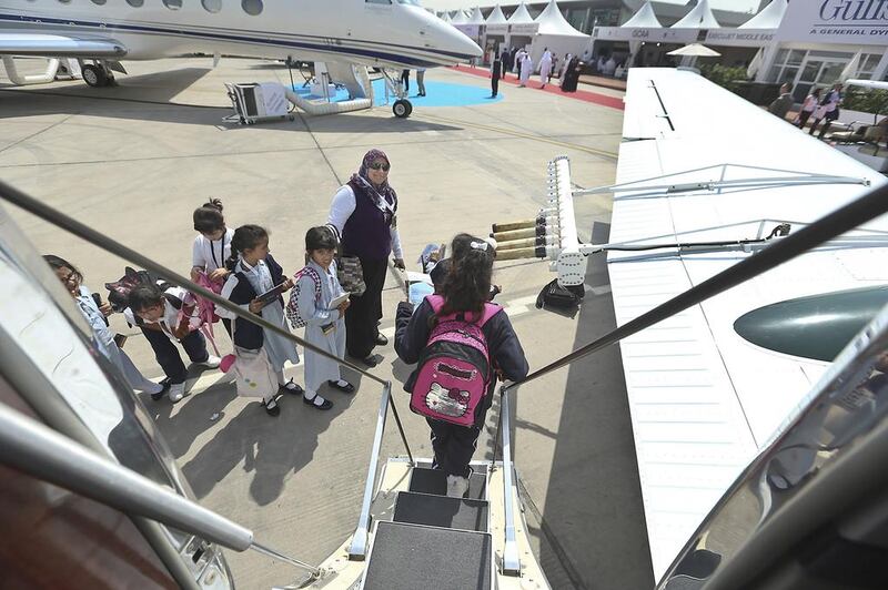 School pupils prepare to board the Ministry of Presidential Affairs plane, which is on display at the Abu Dhabi Air Expo at Al Bateen Executive Airport. Delores Johnson / The National