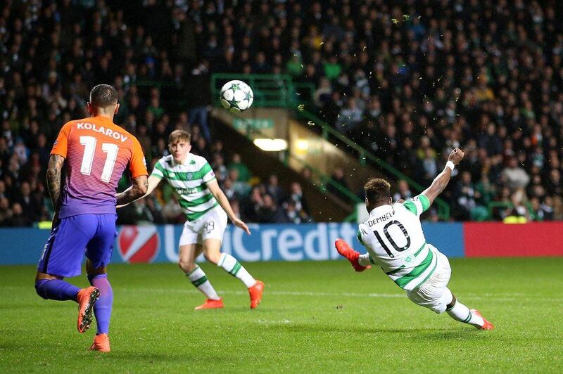 Celtic’s Moussa Dembele, right, scores his side’s third goal of the Champions League match against Manchester City. Jane Barlow / AP