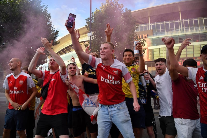 Arsenal fans celebrate outside the Emirates. AFP