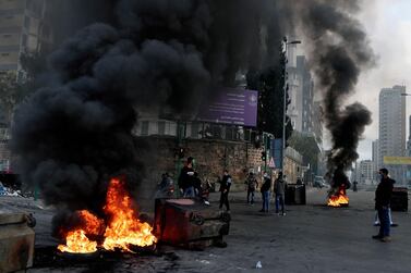 Protesters burn tyres to block a road during a protest in Beirut, Lebanon, March 4, 2021. AP Photo