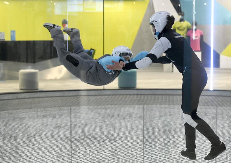 Abu Dhabi, United Arab Emirates - Mazen, 7, takes flight with the help of the instructor during the indoor skydiving adventure at CLYMB, Yas Island. Khushnum Bhandari for The National