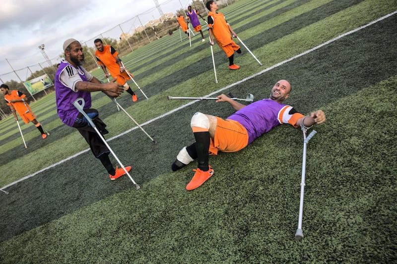 Wahid Rabah, the oldest member of Gaza's new amputee football team , smiles despite falling to the ground during  the team's weekly practise session on July 16,2018. He lost his right leg during an Israeli military operation in 2006 called "Summer Rain," which was launched after an Israeli soldier was captured and taken into Gaza. (Photo by Heidi Levine for The National).