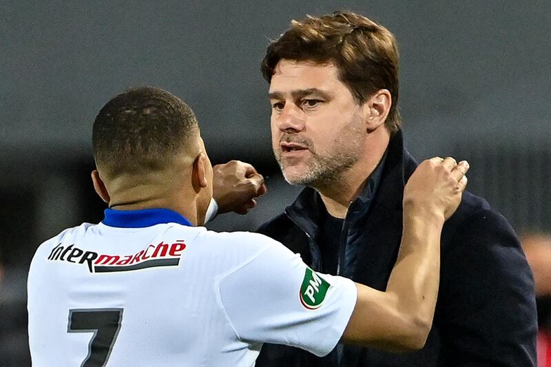 Paris Saint-Germain's Kylian Mbappe celebrates with head coach Mauricio Pochettino. AFP