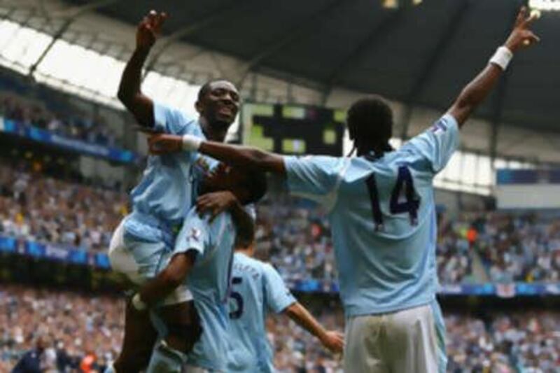 Shaun Wright-Phillips of Manchester City celebrates scoring his team's fourth goal with teammates Robinho and Jo.