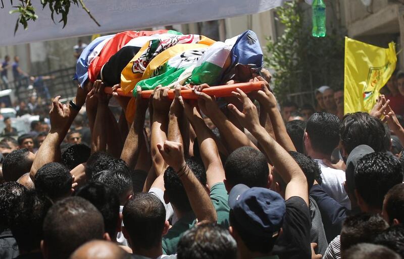 Palestinians carry the body of Ahmad Sabbarin from Jalazoun refugee camp during his funeral in the West Bank near Ramallah on16 June 2014. Sabbarin was killed by Israeli soldiers in the refugee camp during a confrontation with protesters amid large-scale arrests of Palestinians asIsrael searched for three abducted teenagers. EPA/ATEF SAFADI