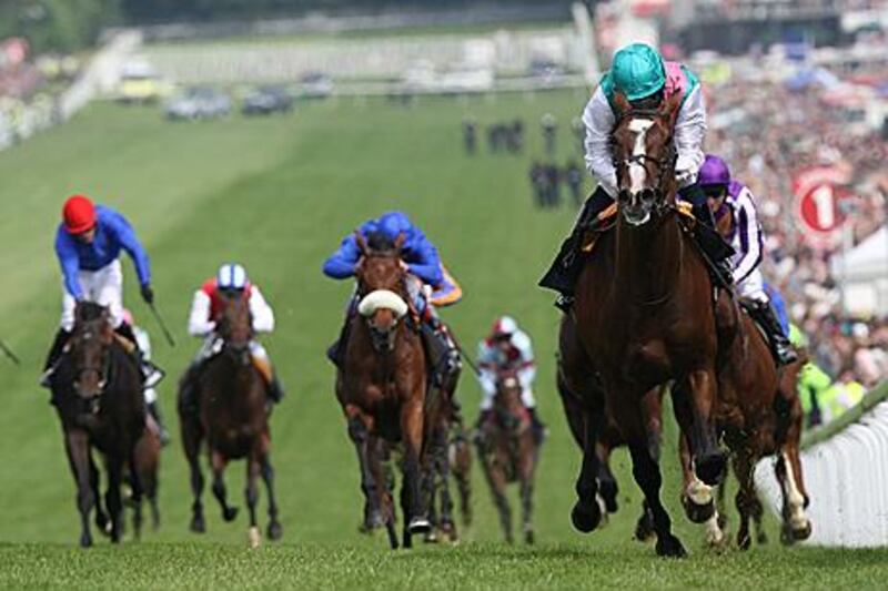 Ryan Moore and Workforce, right, lead the field on the way to winning on Derby Day at Epsom last year.