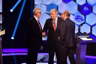 Britain's Prime Minister Boris Johnson and opposition Labour Party leader Jeremy Corbyn shake hands during a head-to-head debate on the BBC in London, Britain December 6, 2019 Reuters