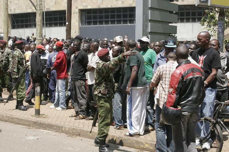 Security officers keep a crowd under control outside the Westgate mall. A witness said that gunmen told Muslims to stand up and leave and that non-Muslims would be targeted. Initial police reports had described the incident as a botched robbery. Jason Straziuso / AP Photo