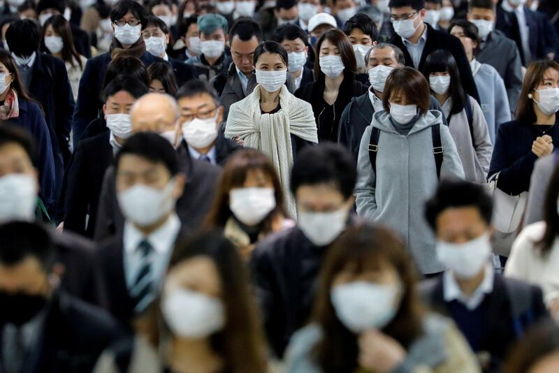 People wear face masks at Shinagawa station during the rush hour after the government expanded a state of emergency to include the entire country following the coronavirus disease  outbreak, in Tokyo, Japan. Reuters