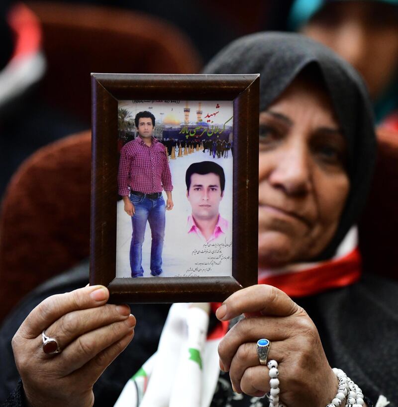 An Iraqi woman carries a picture of an Iranian revolutionary guards member who was killed during the fighting against ISIS during a ceremony honoring of the Iran revolutionary guards fighters in Baghdad, Iraq. EPA