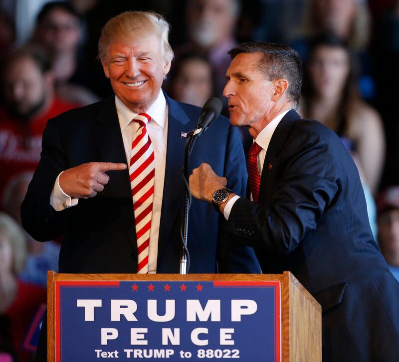 (FILES) This file photo taken on October 17, 2016 shows former Republican presidential candidate Donald Trump (L) as he jokes with retired Gen. Michael Flynn as they speak at a rally at Grand Junction Regional Airport in Grand Junction Colorado. 
Michael Flynn, Donald Trump's former national security advisor, has been charged with lying to investigators over his Russian contacts, becoming the seniormost official indicted in the probe into possible collusion between the Trump campaign and Moscow.
Flynn was charged November 30, 2017 with one count of lying about his private discussions with Sergey Kislyak, the Russian ambassador, regarding US sanctions being imposed on Moscow by the government of then president Barack Obama, a court document showed.
 / AFP PHOTO / GETTY IMAGES NORTH AMERICA / GEORGE FREY