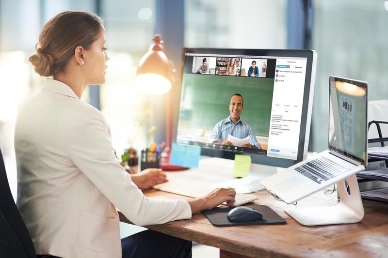 Shot of two colleagues video chatting with each other on a computer at work