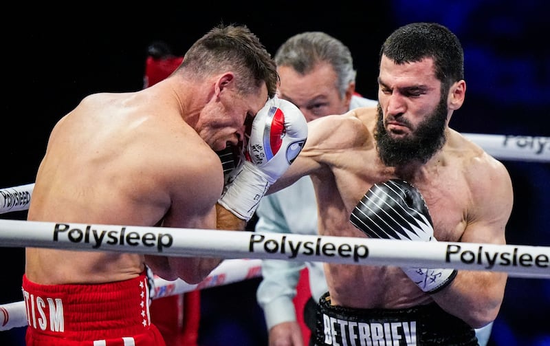 Artur Beterbiev lands a punch on Callum Smith during their light-heavyweight title fight in Quebec City, Canada. on January 13, 2024. AFP