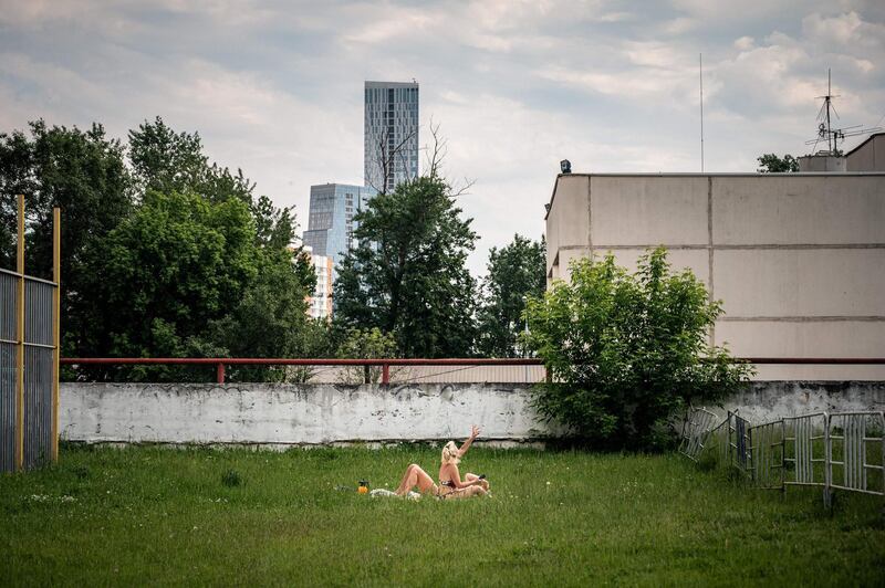 People sunbathe while enjoying warm weather in Moscow.  AFP