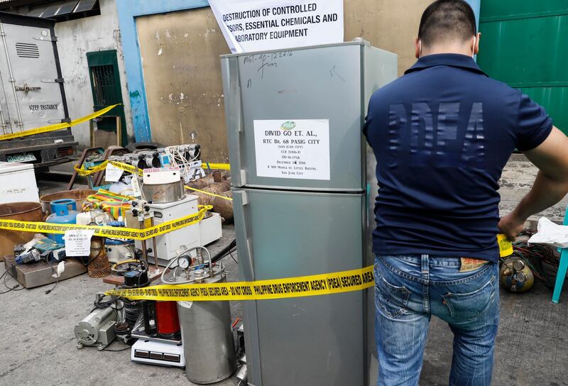 epa06260164 A personnel of the Philippine Drug Enforcement Agency (PDEA) puts caution tape around seized equipment for the manufacture of illegal drugs, before a destruction procedure in Valenzuela City, north of Manila, Philippines, 12 October 2017. The PDEA destroyed seized chemicals, materials and equipment for manufacturing illegal drugs worth some 10.7-million pesos (176,000 euro) as part of an anti-illegal drugs campaign. Philippine President Rodrigo Duterte issued a memorandum dated 10 October giving the PDEA sole responsibility to lead anti-illegal drugs operations in the country, effectively halting operations headed by the Philippine National Police and other government agencies concerned.  EPA/ROLEX DELA PENA