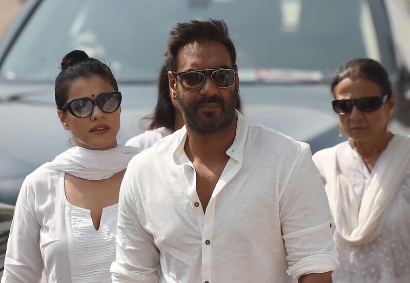 Indian Bollywood actor Ajay Devgan, cente, and his wife Kajol, left, were amongst the celebrity mourners. Punit Paranjpe / AFP Photo