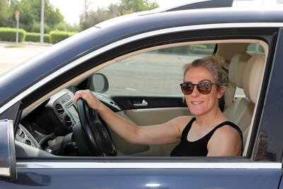 Aimee Middleton sits in the driver's seat of her new car that specialist Paul Willetts helped her to buy. Pawan Singh / The National