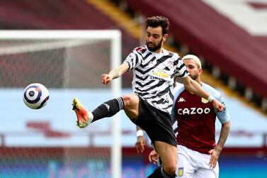 Manchester United's Bruno Fernandes, front, duels for the ball with Aston Villa's Douglas Luiz during the English Premier League soccer match between Aston Villa and Manchester United at Villa Park in Birmingham, England, Sunday, May 9, 2021. (Michael Steele/Pool via AP)