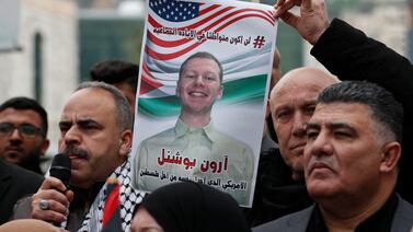 A man holds a photo of late US airman Aaron Bushnell, who died of his injuries after setting himself on fire outside the Israeli embassy in Washington  while shouting Free Palestine, in the West Bank city of Nablus, on February 27.  EPA