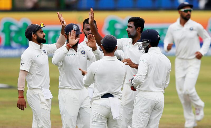 Cricket - Sri Lanka v India - Third Test Match - Pallekele, Sri Lanka - August 14, 2017 - India's Ravichandran Ashwin celebrates with captain Virat Kohli , Cheteshwar Pujara and his teammates after taking the wicket of Sri Lanka's Dimuth Karunaratne (not pictured). REUTERS/Dinuka Liyanawatte