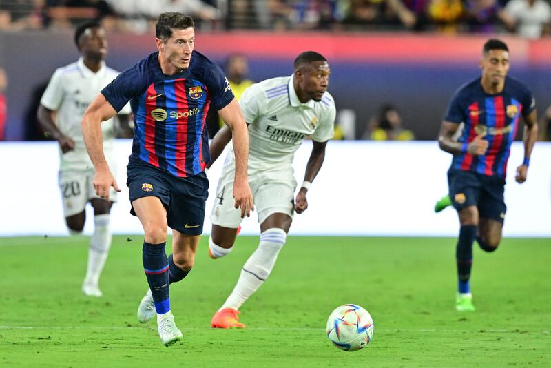 Robert Lewandowski runs with the ball during the match between Barcelona and Real Madrid. AFP