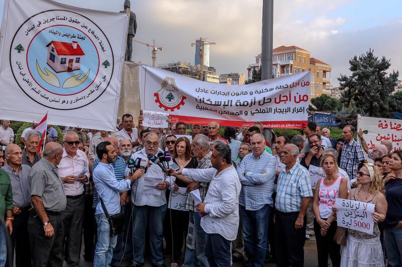 Lebanese workers carry placards and shouts slogans during a sit-in at downtown Beirut, demanding salary increases for workers, and rejecting a surge in the price of petrol. EPA