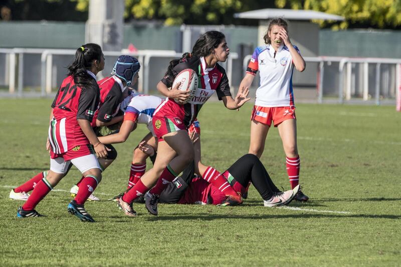 ABU DHABI, UNITED ARAB EMIRATES. 29 November 2018. First day of the Rugby Sevens Tournament. Al Maha School girls team of all Emirati Female Players (Red and black colours). (Photo: Antonie Robertson/The National) Journalist: Paul Radley. Section: Sport.