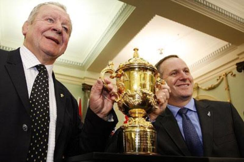 John Key, the New Zealand prime minister, right, and Bil Beaumont, IRB deputy chairman, hold one of the Webb Ellis trophies. New Zealand world cup organisers admitted that there are two cups, one a duplicate.