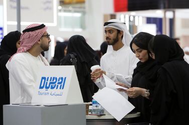 Emirati jobseekers speak to recruiters at Careers UAE at Dubai World Trade Centre. Leslie Pableo for The National