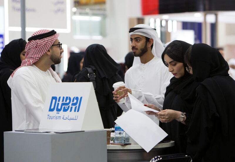 DUBAI, UNITED ARAB EMIRATES - Emirati job seekers speaking to recruiters at the Careers UAE 2019 at Dubai World Trade Centre.  Leslie Pableo for The National for Patrick Ryan's story