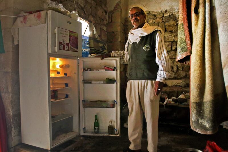 A Lebanese man displays the content of his refrigerator at his apartment in the southern city of Sidon. AFP