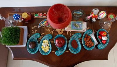 epa09085039 A traditional table is set, including seven items all starting with the letter 'sin' in the Persian alphabet, ahead of New Year celebrations in Tehran, Iran, 20 March 2021. The New Year, which has been celebrated for at least 3000 years, is one of the most important celebrations in the greater Persian world, which includes the countries of Iran, Afghanistan, Azerbaijan, Turkey, and portions of western China and northern Iraq, and is traditionally celebrated on the Spring equinox, the day when the duration of night and day are roughly equivalent, usually falling on the 20 or 21 March.  EPA/ABEDIN TAHERKENAREH