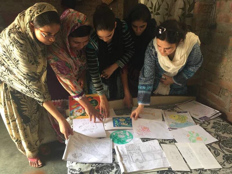 Women have their worked checked in a free literacy class in Uttar Pradesh. Courtesy Kidwai family