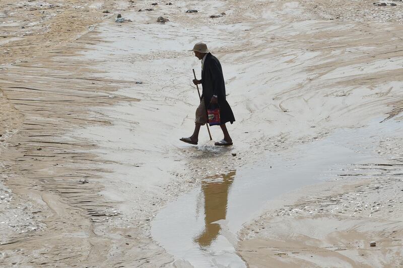 A man walks in a flooded road in the Tunisian coastal governorate of Nabeul. AFP