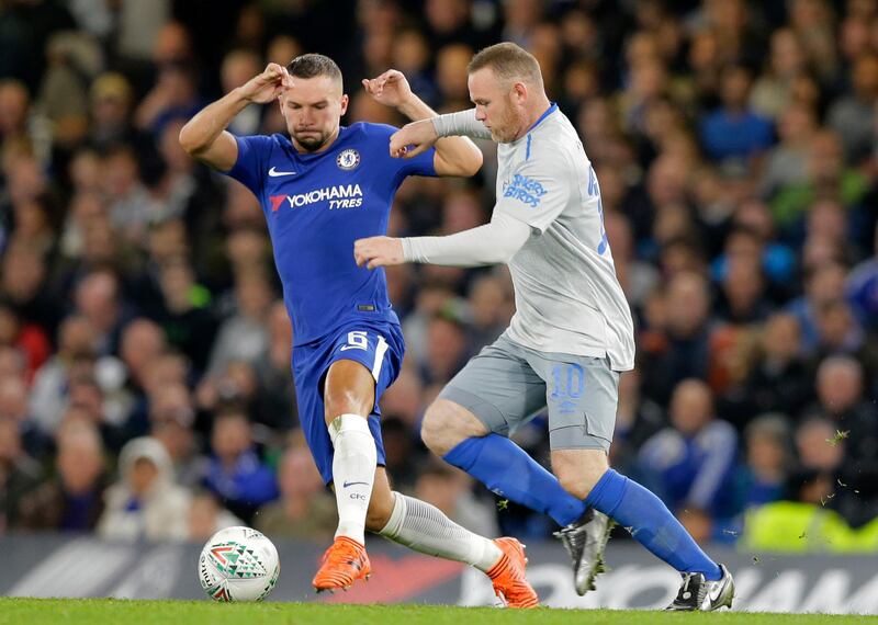 Chelsea's Danny Drinkwater, left, goes to tackle Everton's Wayne Rooney during their English League Cup soccer match between Chelsea and Everton at Stamford Bridge stadium in London, Wednesday,Oct. 25, 2017. (AP Photo/Alastair Grant)