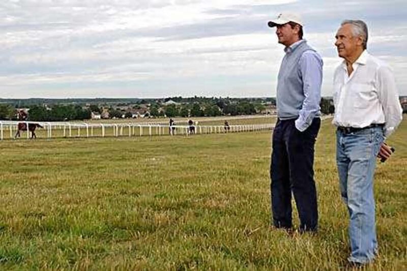 Bruce Raymond on Warren Hill, watching his horses go through their paces with David Simock, one of 19 trainers employed by Rabbah Bloodstock.