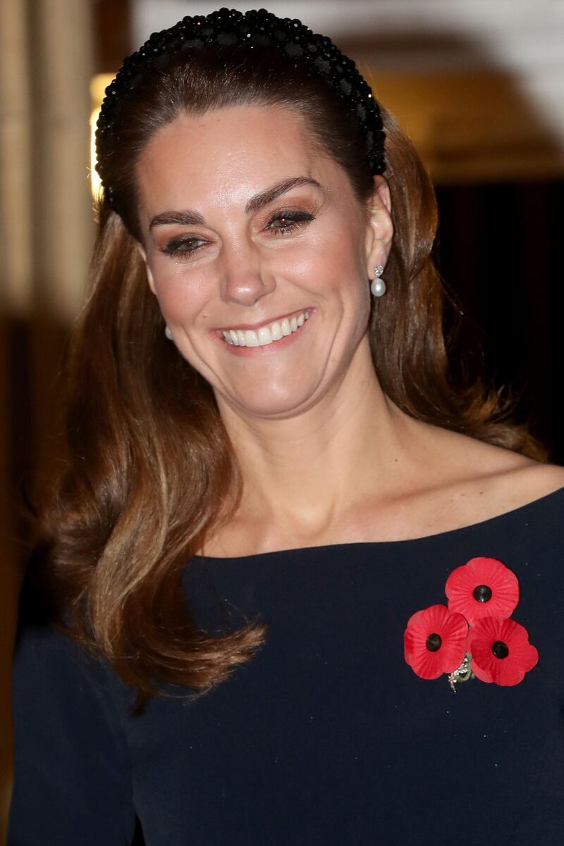 The Duchess of Cambridge wore a trio of poppies for the annual event. AFP