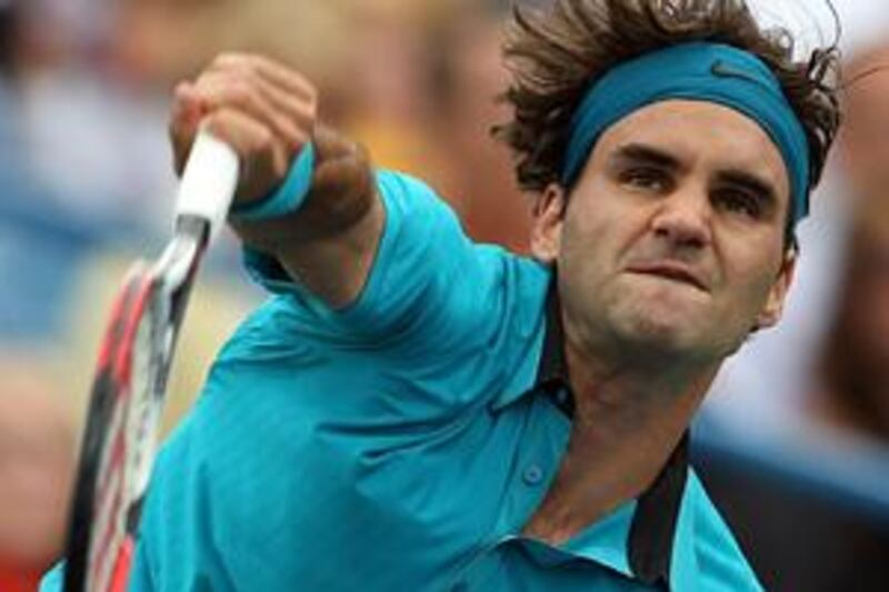 Roger Federer serves against Novak Djokovic on his way to victory in Cincinnati.
