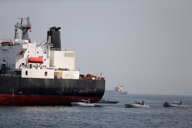 FILE PHOTO: UAE Navy boats are seen next to the Saudi tanker Al Marzoqah off the Port of Fujairah, UAE, May 13, 2019.REUTERS/Satish Kumar/File Photo