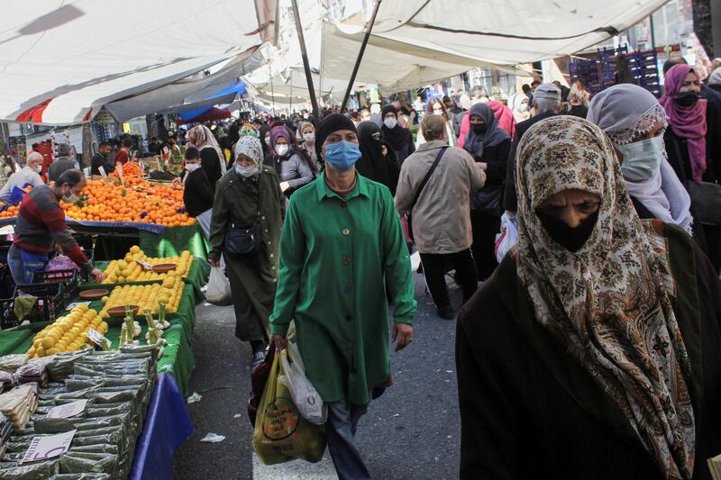 People wearing protective face masks shop at a fresh market, amid the coronavirus disease (COVID-19) pandemic, in Istanbul, Turkey April 26, 2021. REUTERS/Dilara Senkaya