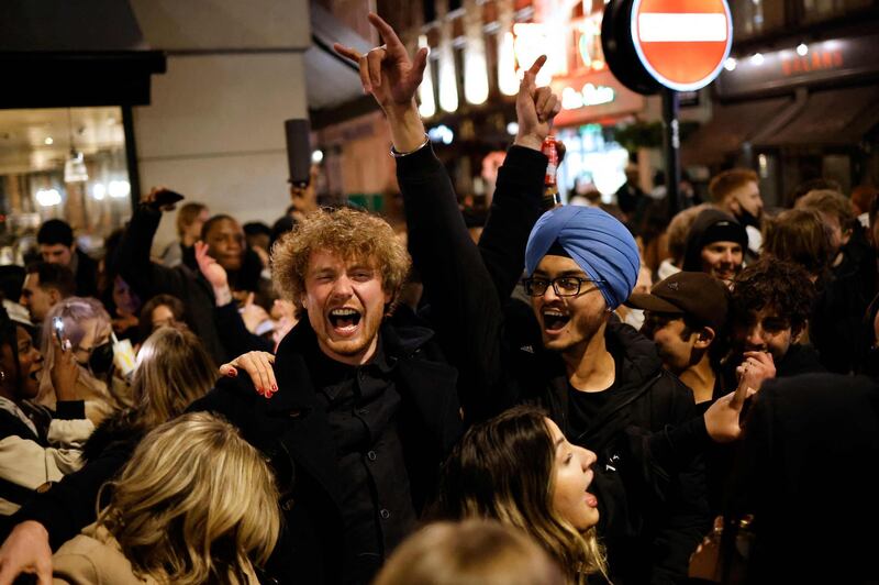 People gather in the street in the Soho area of London, as coronavirus restrictions are eased across the country in step two of the government's roadmap out of England's third national lockdown. AFP