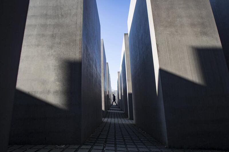 A visitor walks through the Holocaust Memorial in Berlin, Germany. Ian Langsdon / EPA