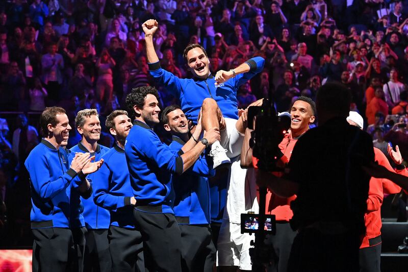 Roger Federer is hoisted by Team Europe teammates after playing his final match. AFP