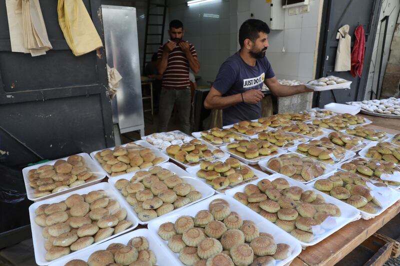 Palestinians prepare ma'moul and kahk in the West Bank city of Nablus. EPA