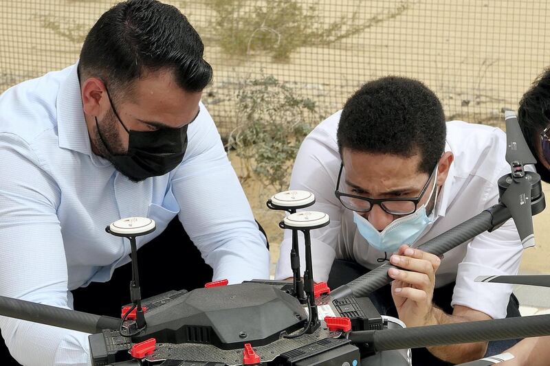 DUBAI, UNITED ARAB EMIRATES , March 16, 2021 – Ahmed Borik - IoT Systems Engineer (right) with the Cafu drone during the press conference at the Sanad Academy, Skyhub RC Club in Dubai. Cafu is using drones to plant 1 million Ghaf seeds in the UAE. (Pawan Singh / The National) For News/Online/Instagram/Big Picture. Story by Patrick