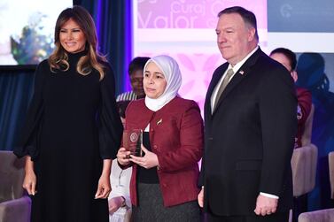 International Women of Courage (IWOC) Award recipient Amina Khoulani of Syria poses with US Secretary of State Mike Pompeo (R) and First Lady Melania Trump at the State Department in Washington, DC on March 4, 2020. / AFP / MANDEL NGAN