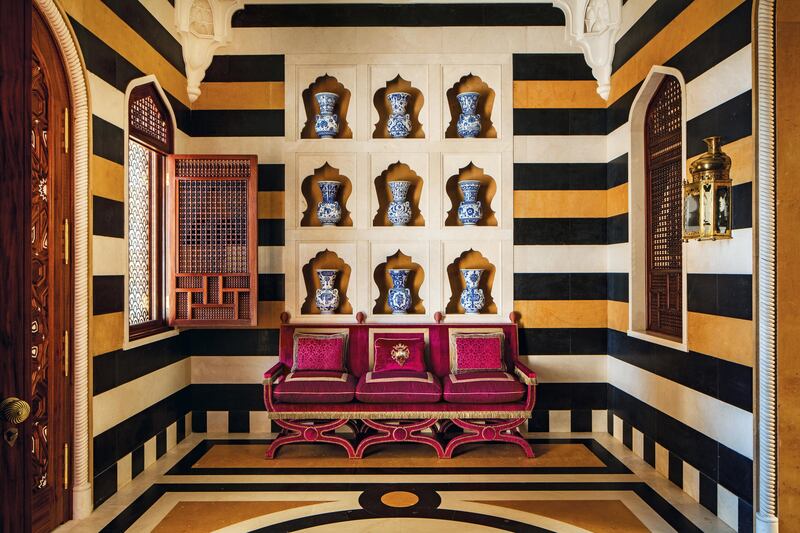 This hallway expresses both austere masculinity and light-hearted femininity. â€˜ I love the fine balance between the two and  the mixture is a critical part of my work.  The chic of the yellow, black and ivory marble stripes is delightful with the carved stone alcoves, each containing a sixteenth-century-style Turkish blue-and-white mosque lamp.  The elongated settee is modern but based on early European chairs, and is finished with detailed stud and braid work. This is yet another example of an Alidad hybrid, where a Western reference has been transported into an essentially Ottoman inspired space. I relish these surprising combinations blended with the graphic marble floor and the delicacy of the Mashrabiya grillwork on the windows.â€™

(Photo by James McDonald) *** Local Caption ***  WK19JL-HH-ALIDAD01.jpg