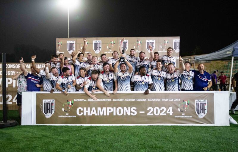 Jebel Ali Dragons celebrate with the UAE Premiership trophy after beating Dubai Hurricanes in the final at Al Ain Amblers Club. All photos Ruel Pableo for The National