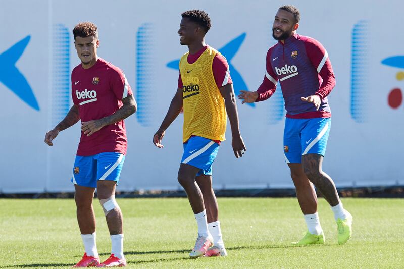 Barcelona players Philippe Coutinho, left, Ansu Fati and Memphis Depay. EPA